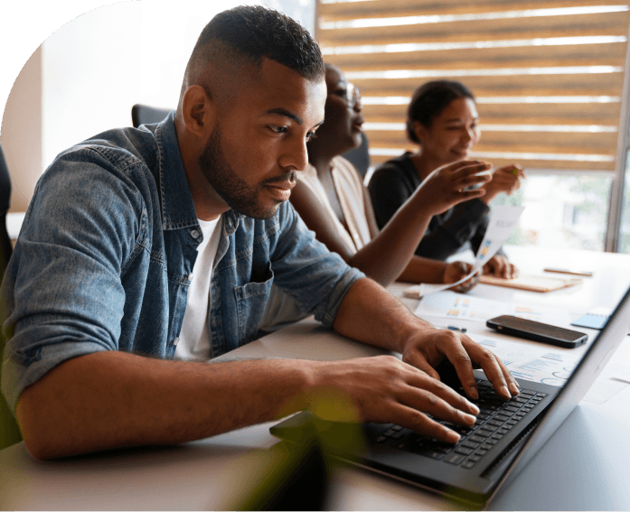 three men and a lady looking at a laptop